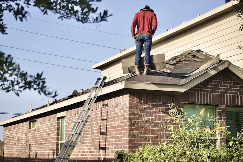 Professional roofer working on a residential roof in Sunrise Oaks